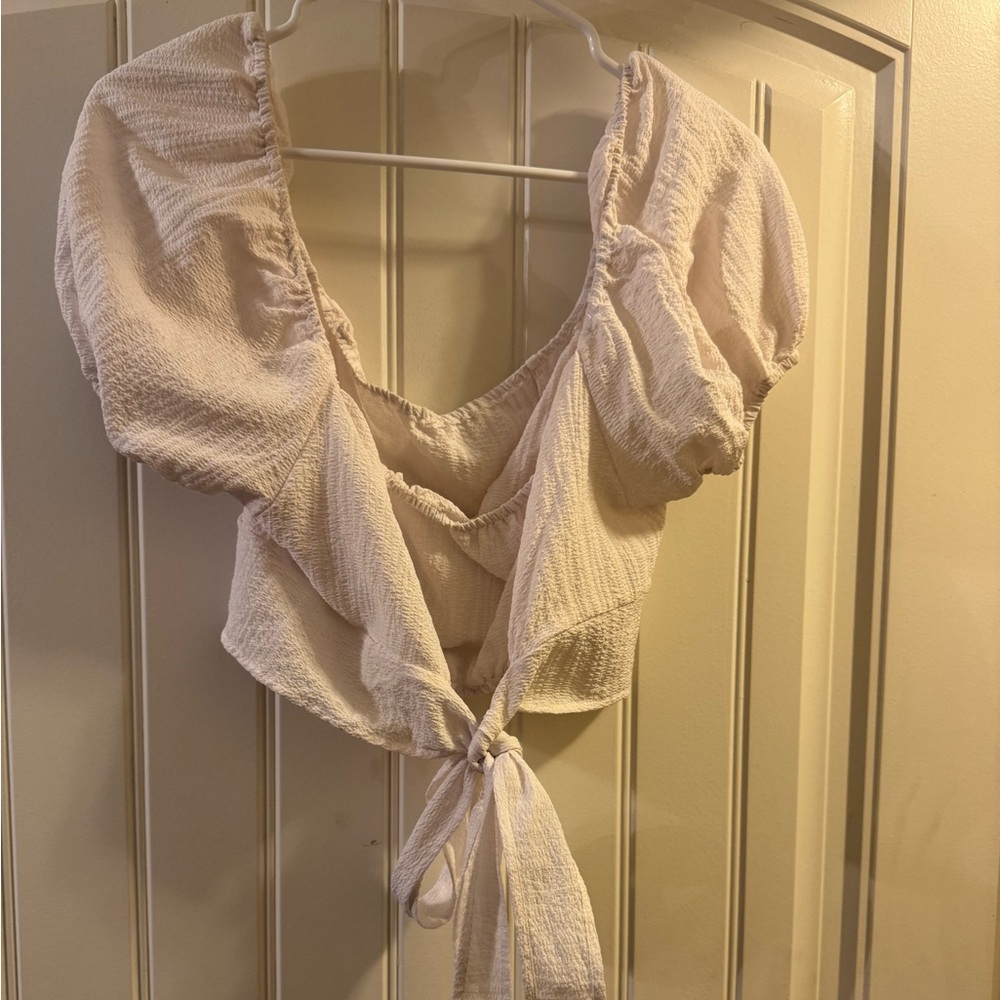White top, crosses in the back